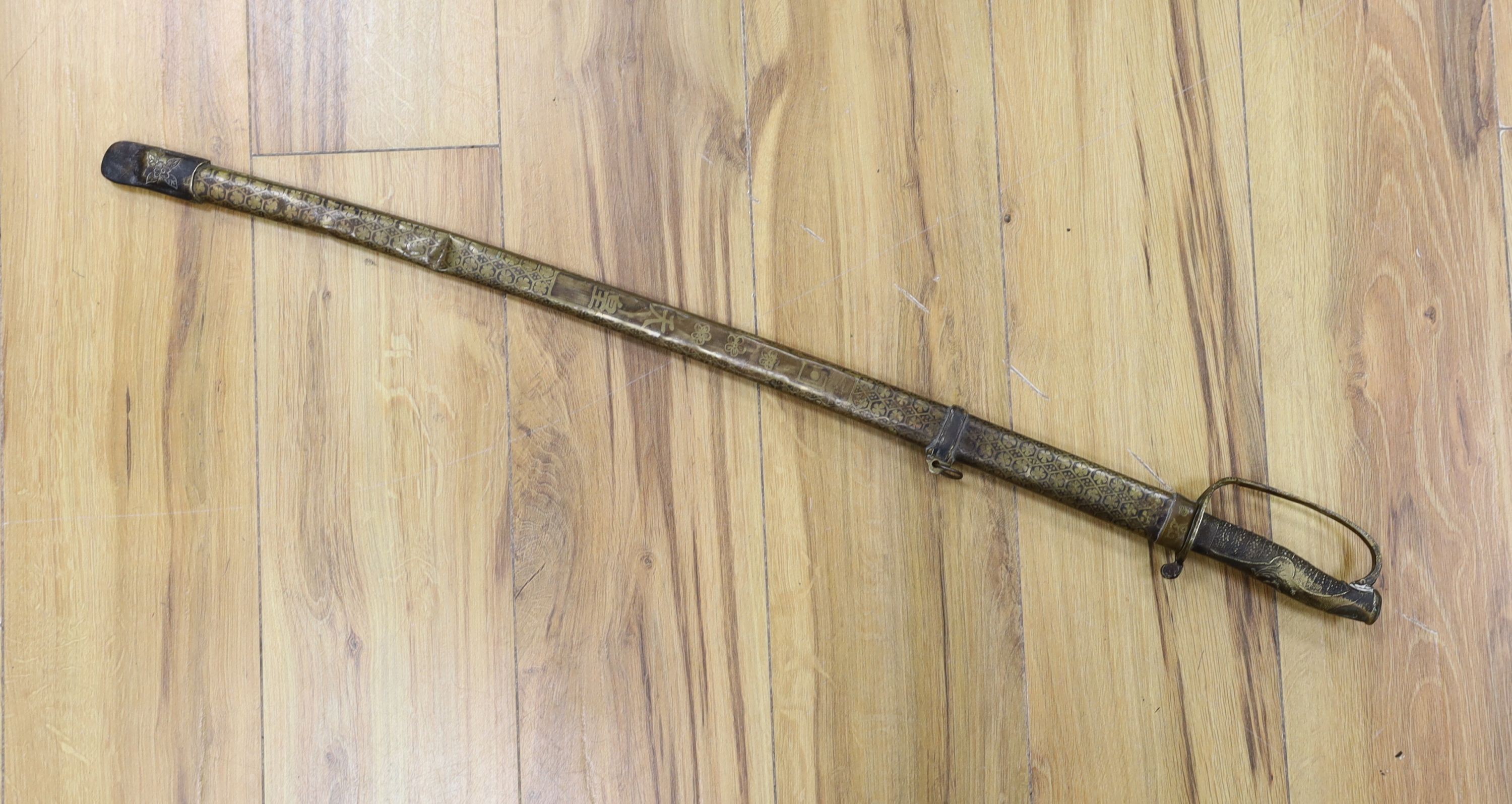 A Chinese sword, single edged blade 64cm long in etched brass scabbard